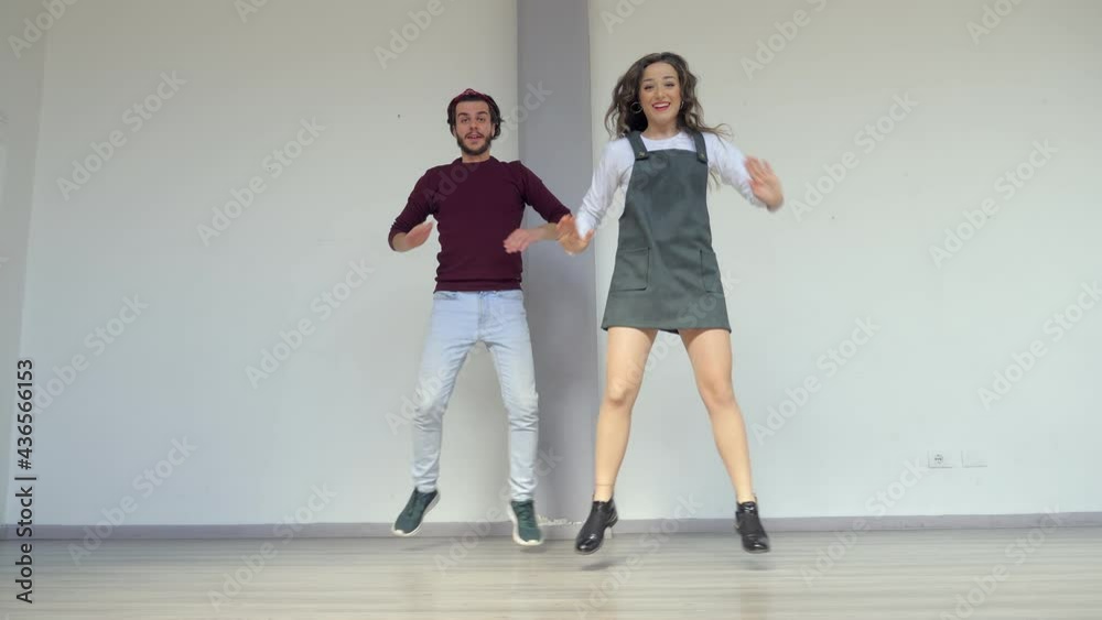 synchronized dance - young couple dance in funky style in front of the camera synchronized dance - young couple dance in funky style in front of the camera