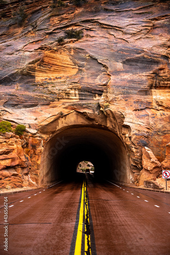 Red Road Leads into Tunnel Through Rock photo