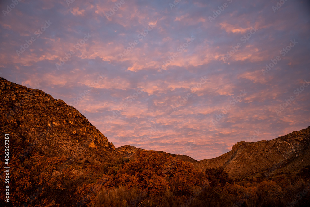 Rows of Pink Tinted Clouds Over Guadalupe Mountains