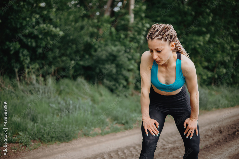 Fit sporty woman take breath at jogging workout Fit sporty woman take breath at jogging workout