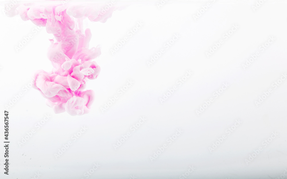 Obraz premium Color drop in water, photographed in motion. pink ink in water isolated on white background. Background and texture.