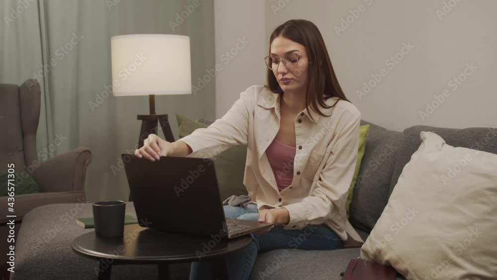 White girl puts on glasses and turns on the computer. White girl puts on glasses and turns on the computer.