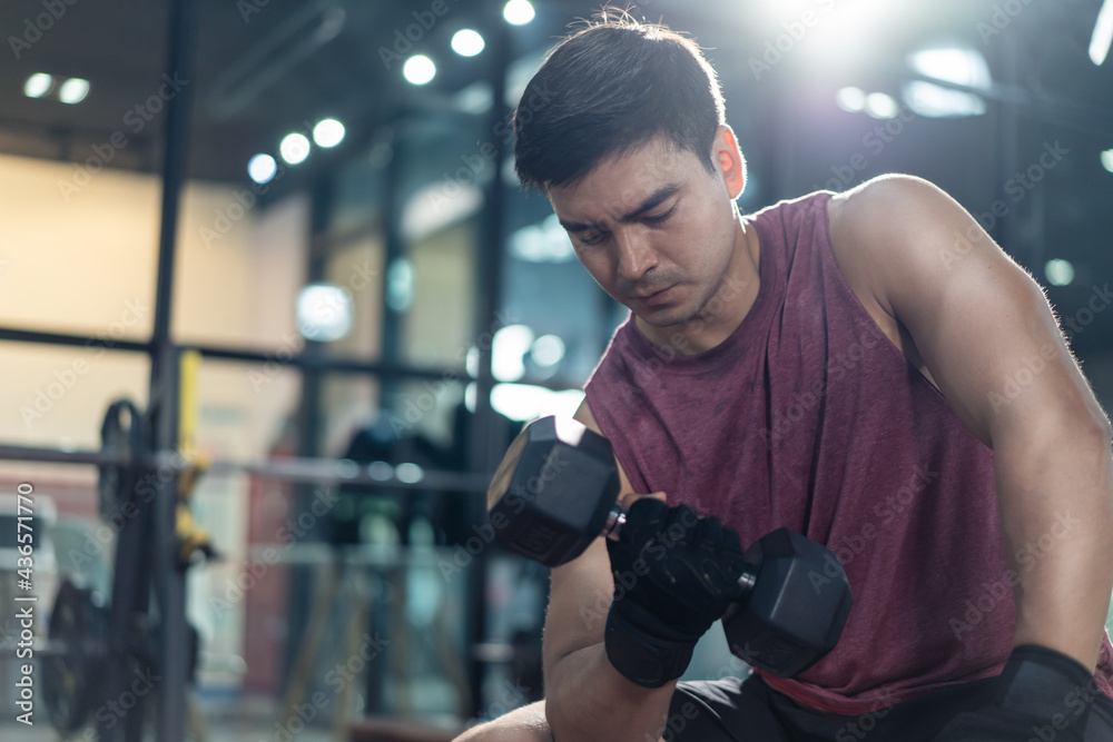 Active athlete sport man workout lift dumbbell exercise at fitness gym Active athlete sport man workout lift dumbbell exercise at fitness gym