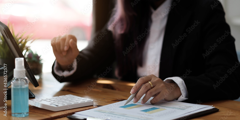 Business woman using calculator for do math finance on wooden desk in office and business working background, tax, accounting, statistics and analytic research concept Business woman using calculator for do math finance on wooden desk in office and business working background, tax, accounting, statistics and analytic research concept