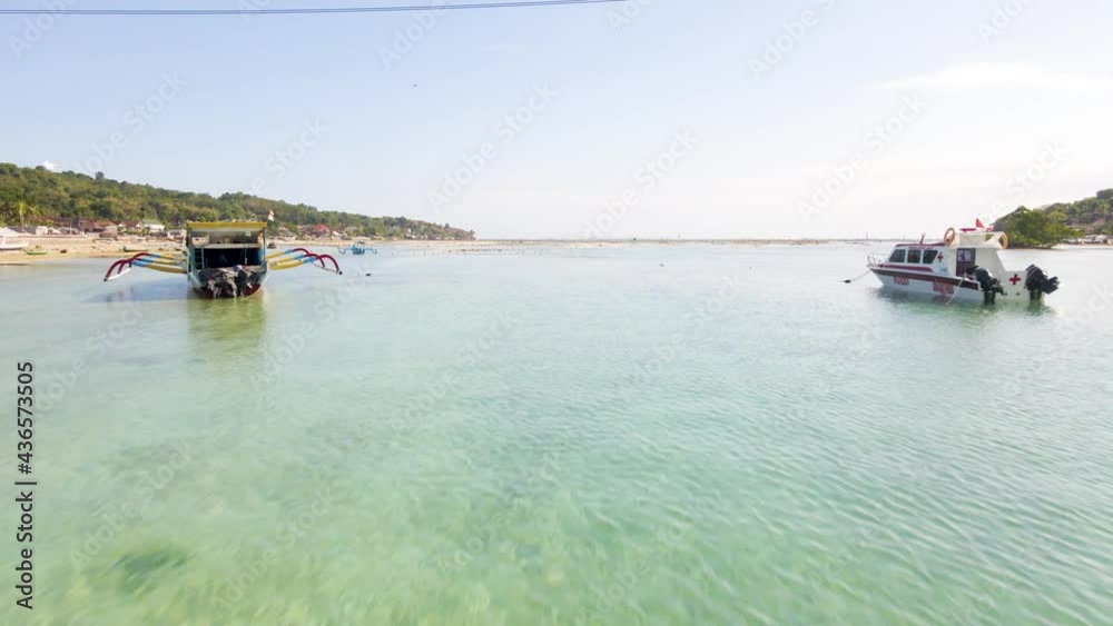 Aerial Drone Shot Flying Under Yellow Bridge Coastline Crystal Clear Blue Water Filled With Fishing Boats in Nusa Lembongan Ceningan, Bali Indonesia Aerial Drone Shot Flying Under Yellow Bridge Coastline Crystal Clear Blue Water Filled With Fishing Boats in Nusa Lembongan Ceningan, Bali Indonesia