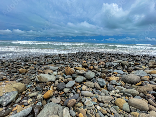 Beautiful closeup view of the Dominical Beach shore field with rocks in Costa Rica