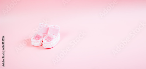 baby pink booties with a picture of a bear on a pink background