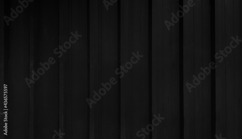 Black stainless steel background. Dark shutter door wall with copy space. Line pattern of curtain or zinc wallpaper. 