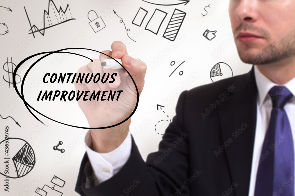 Business, technology, internet and network concept. Young businessman thinks over the steps for successful growth: Continuous improvement Business, technology, internet and network concept. Young businessman thinks over the steps for successful growth: Continuous improvement
