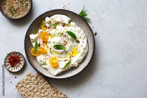 Homemade yogurt cheese (labneh) with tomatoes, seeds and olive oil