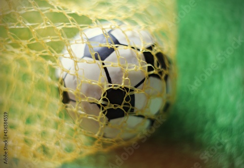 Fototapeta Naklejka Na Ścianę i Meble -  Soccer ball in goal, sport and success business concept.