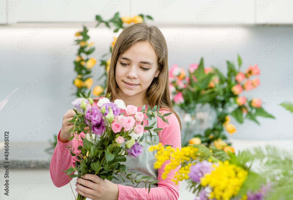 Smiling young girl arranging flower at flower shop. Hobby and leisure concept Smiling young girl arranging flower at flower shop. Hobby and leisure concept