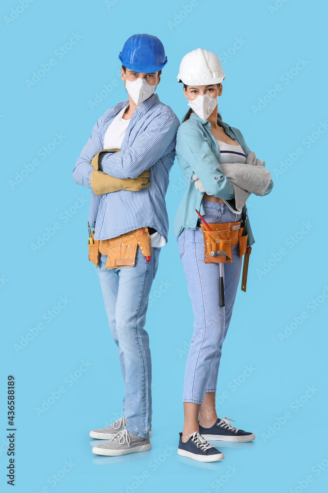 Happy couple with repair tools on color background Happy couple with repair tools on color background