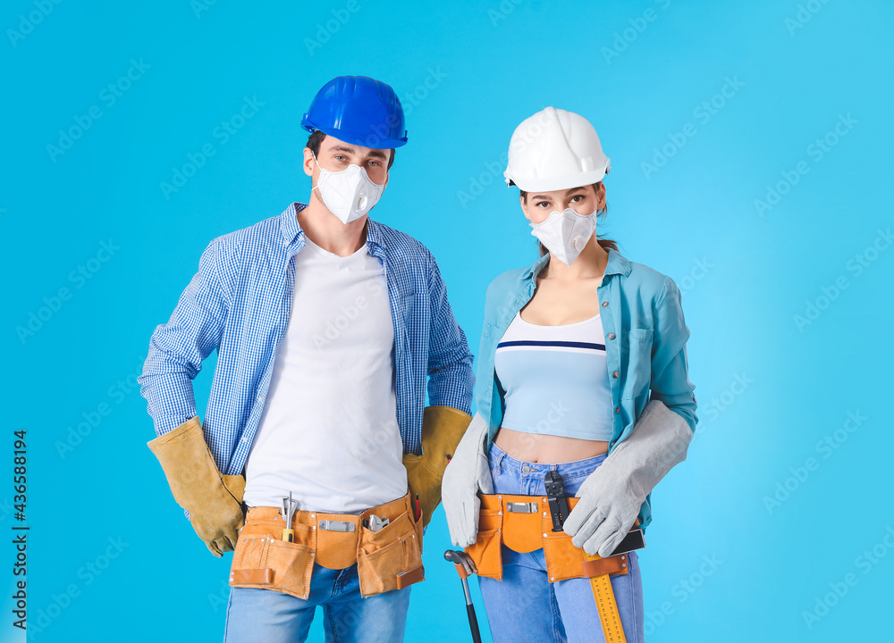 Happy couple with repair tools on color background Happy couple with repair tools on color background