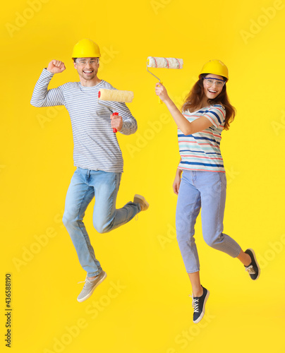 Happy couple jumping with p...