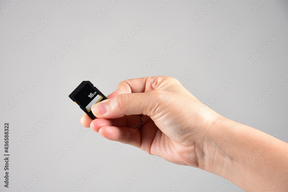 Hand holding SD card isolate on white background Hand holding SD card isolate on white background