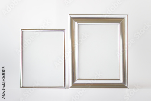 Set of two silver glossy metallic frames with blank space on white background. © dariaren