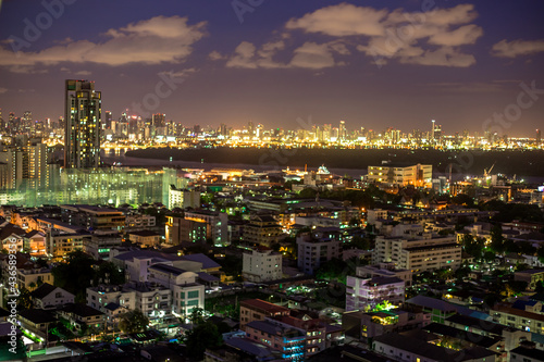 The high angle background of the city view with the secret light of the evening  blurring of night lights  showing the distribution of condominiums  dense homes in the capital community