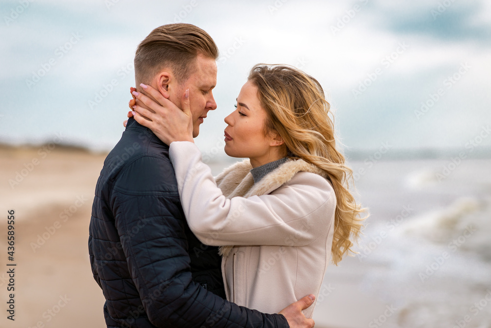 Two Young couple standing enjoying on a coast and enjoying each other.Summer,spring,autumn vacation. Two Young couple standing enjoying on a coast and enjoying each other.Summer,spring,autumn vacation.