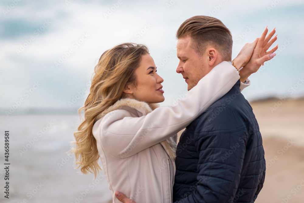 Two Young couple standing enjoying on a coast and enjoying each other.Summer,spring,autumn vacation. Two Young couple standing enjoying on a coast and enjoying each other.Summer,spring,autumn vacation.