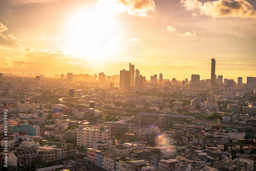 Fototapeta premium The high angle background of the city view with the secret light of the evening, blurring of night lights, showing the distribution of condominiums, dense homes in the capital community