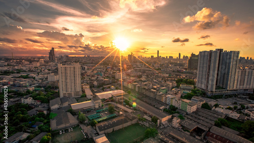 The high angle background of the city view with the secret light of the evening, blurring of night lights, showing the distribution of condominiums, dense homes in the capital community