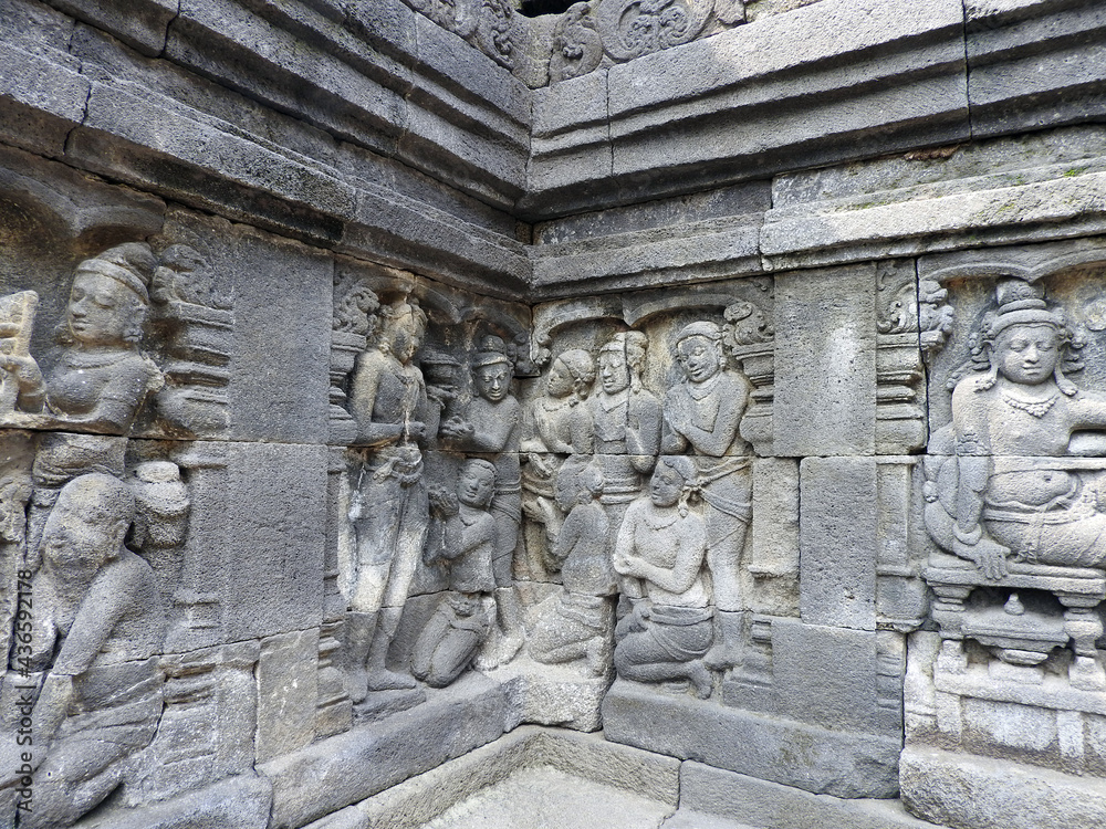 stone relief panels in the ninth century mahayana buddhist temple of borobodur,  in magelang, java, indonesia        