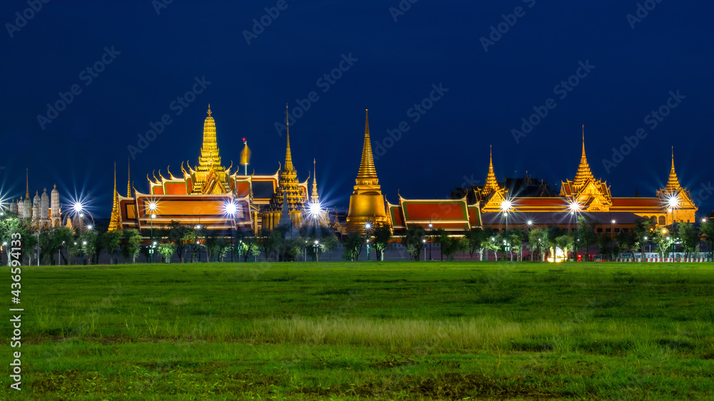 Naklejka premium Golden Night light of Wat Phra Kaew (View from the lawn or Sanam Luang), grand palace or Temple of the Emerald Buddha .