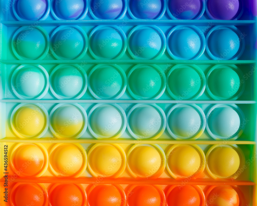 Colorful rainbow anti-stress fidget push pop it sensory toys for children. Simple dimple. Colorful rainbow anti-stress fidget push pop it sensory toys for children. Simple dimple.