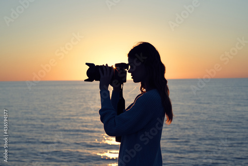 woman photographer with professional camera landscape sunset fresh air