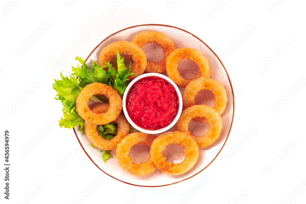 Calamari rings, isolated. A plate of deep fried squid rings with green salad leaves and ketchup, overhead shot on a white background Calamari rings, isolated. A plate of deep fried squid rings with green salad leaves and ketchup, overhead shot on a white background