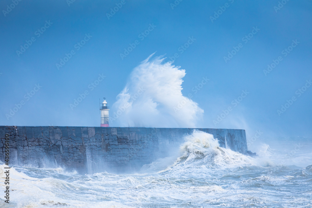 Crashing waves and stormy waters at Newhaven Lighthouse East Sussex, south east England