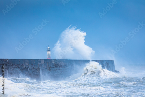 Crashing waves and stormy waters at Newhaven Lighthouse East Sussex, south east England photo