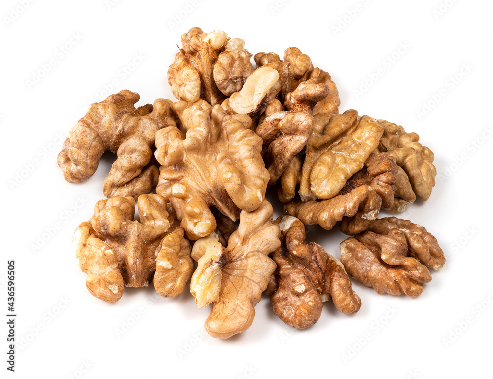 pile of shelled walnuts closeup on white pile of shelled walnuts closeup on white