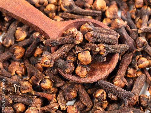 spoon on pile of dried cloves closeup