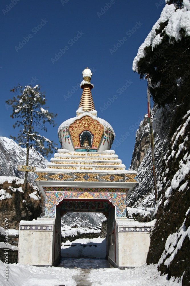 Buddhist chortens with new snow on the trail, Annapurna Himal in Nepal