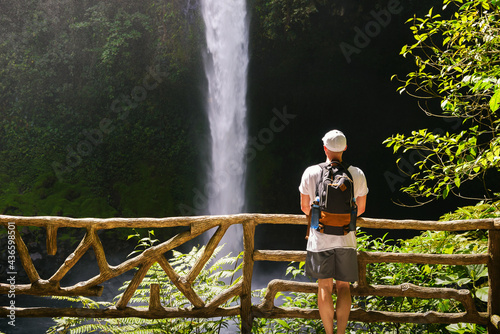 Tourist looking at the La Fortuna Waterfall in Costa Rica photo