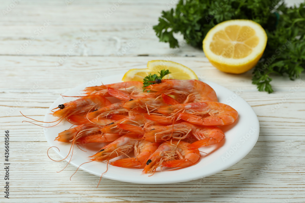 Plate with tasty shrimps on white wooden table Plate with tasty shrimps on white wooden table