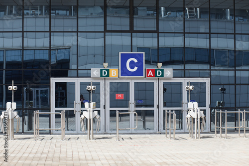 Glass doors and turnstiles, entrance to the indoor stadium arena, airport. No people or visitors. Terminal.