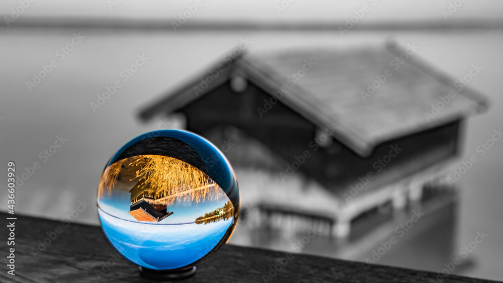 Crystal ball alpine landscape shot with black and white background outside the sphere at the famous Chiemsee, Chieming, Chiemgau, Bavaria, Germany Crystal ball alpine landscape shot with black and white background outside the sphere at the famous Chiemsee, Chieming, Chiemgau, Bavaria, Germany