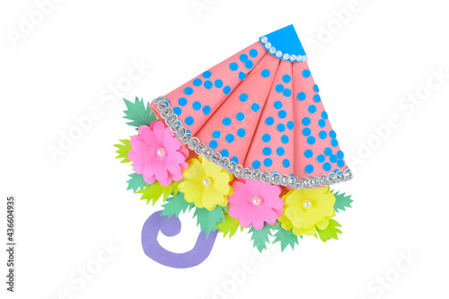 One pink and blue colored handmade crafted umbrella placed on a white paper