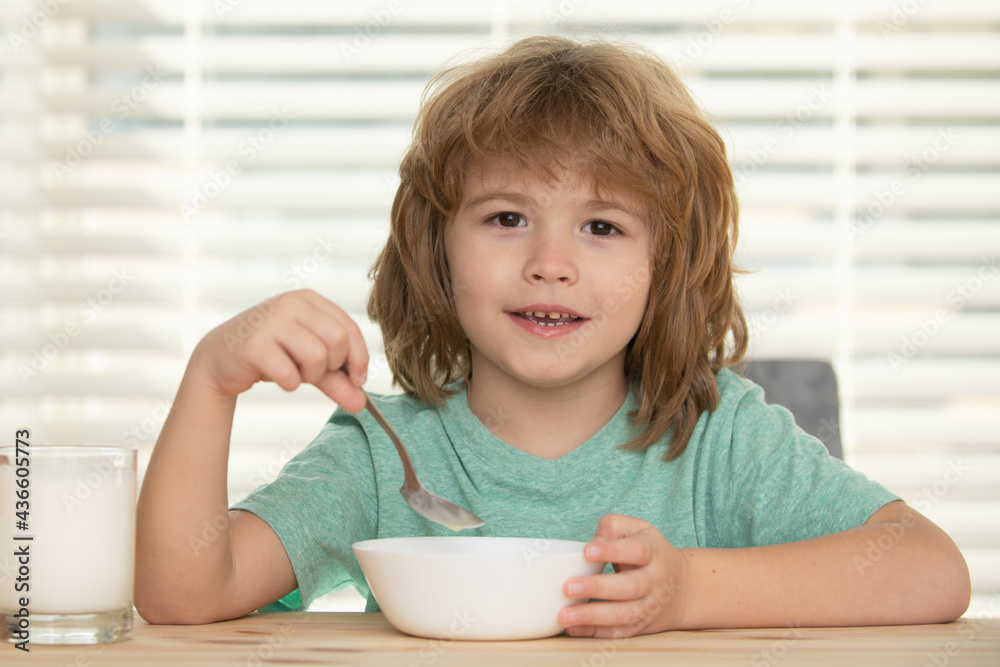 Caucasian toddler child boy eating healthy soup in the kitchen. Caucasian toddler child boy eating healthy soup in the kitchen.