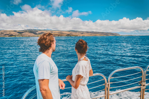 Cruise ship couple on summer Caribbean travel vacation relaxing on boat deck looking at sea. Man and woman tourists on outdoor balcony.