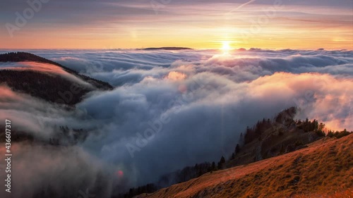 Sunset in autumn mountains above the clouds during the weather inversion in Slovakia. Time lapse landscape. photo