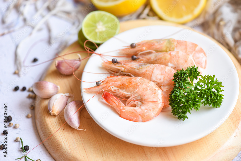 Garlic shrimp on white plate background on the table food kitchen, Fresh shrimps prawns seafood lemon lime with herbs and spice Garlic shrimp on white plate background on the table food kitchen, Fresh shrimps prawns seafood lemon lime with herbs and spice