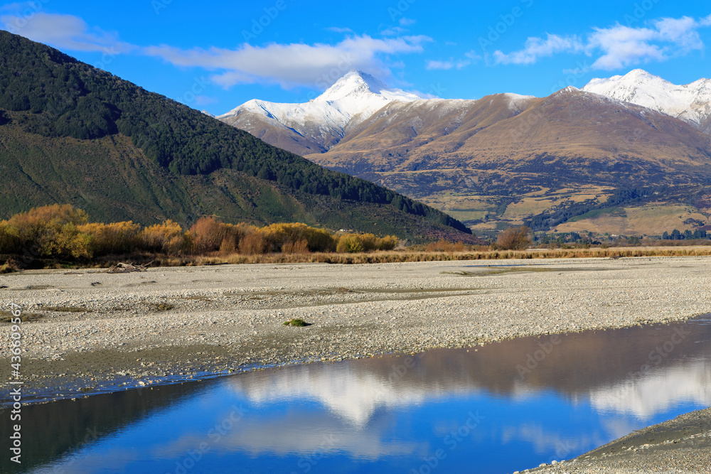 Landscape just north of Glenorchy in the South Island of New Zealand. Mountains of the Southern Alps reflected in the Dart River