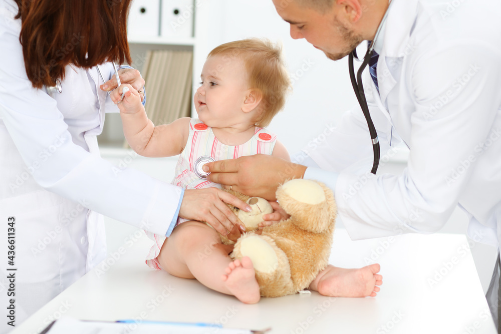 Happy smiling girl-child at usual medical inspection. Doctor and female toddler patient in the clinic. Medicine concept Happy smiling girl-child at usual medical inspection. Doctor and female toddler patient in the clinic. Medicine concept