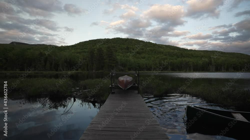 Canoe Boat On Wooden Boardwalk At Lake During Dusk At The Forest Of Le Vertendre In Eastman, Quebec Canada. - Static Shot Canoe Boat On Wooden Boardwalk At Lake During Dusk At The Forest Of Le Vertendre In Eastman, Quebec Canada. - Static Shot