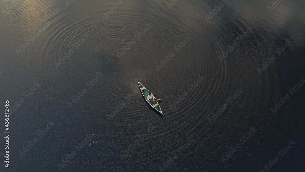 Man Boating On Calm Lake At Forested Resort Of The Vertendre In Eastman, Quebec Canada. - Aerial Shot Man Boating On Calm Lake At Forested Resort Of The Vertendre In Eastman, Quebec Canada. - Aerial Shot