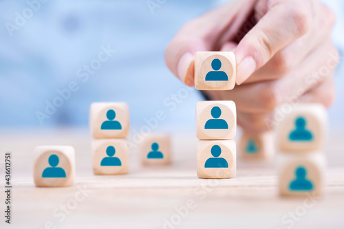 Businessman hand arranging wooden block with emoticon Person icons , Human resource management and recruitment business Organization structure and team building concept